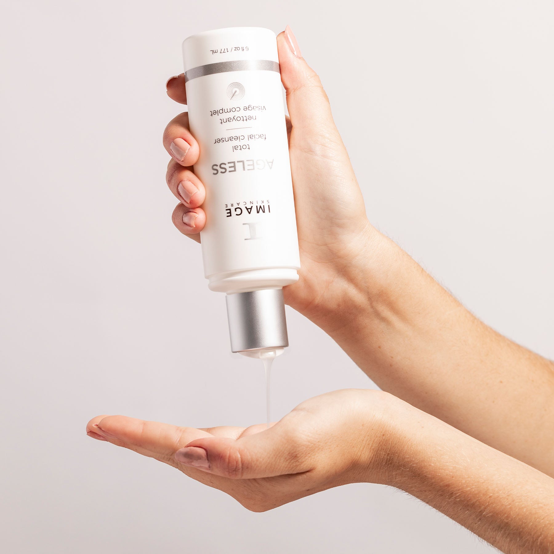 Person dispensing IMAGE Skincare Ageless Total Facial Cleanser - glycolic acid cleanser for youthful, radiant skin