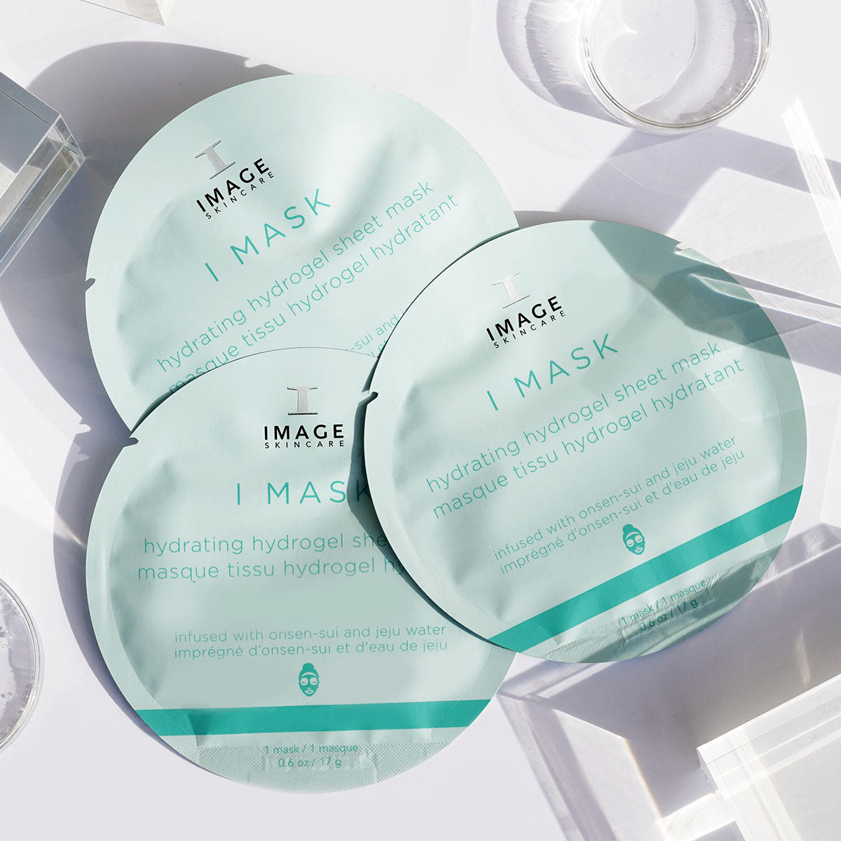 3 sheet masks in packaging on white background