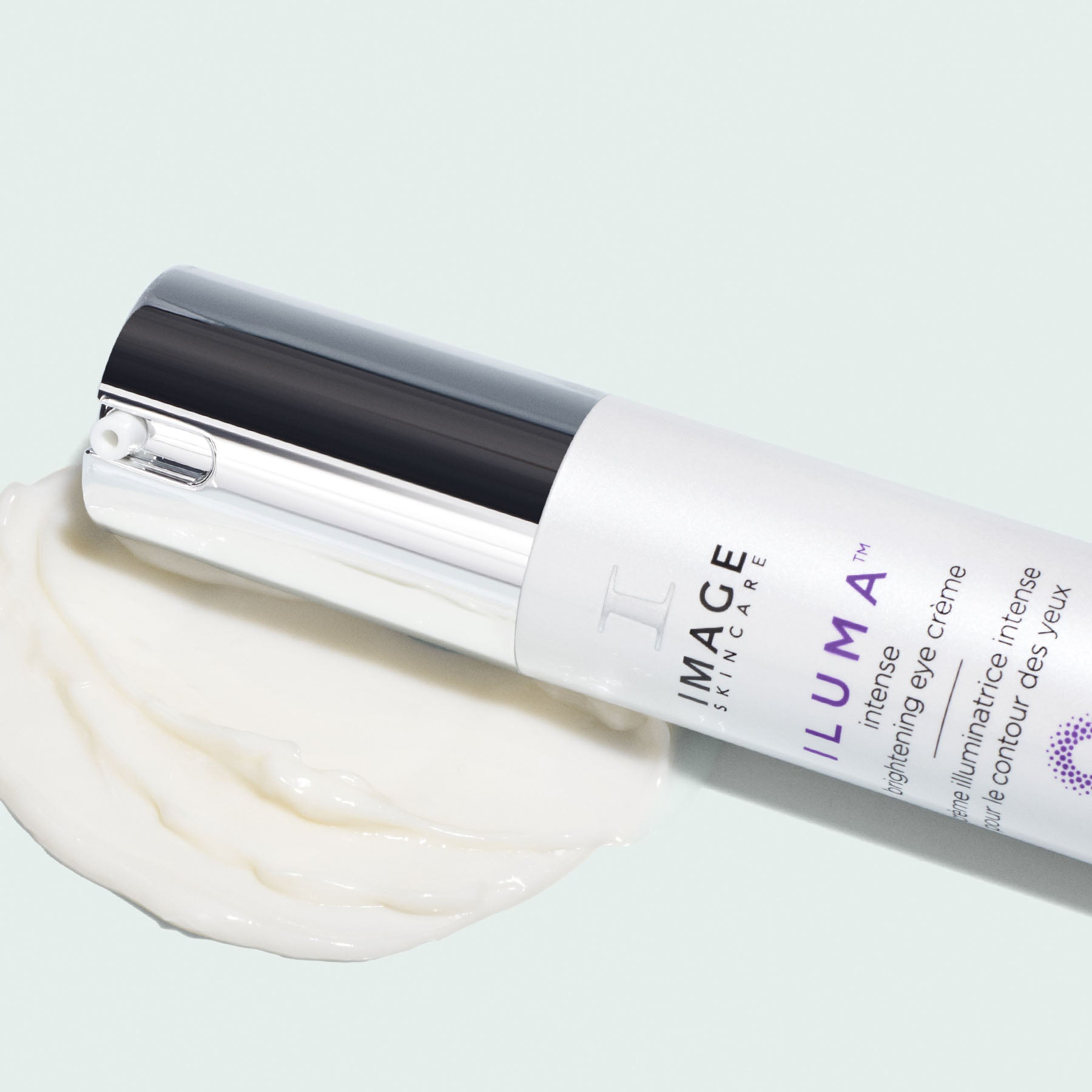 eye creme bottle laying on texture swatch