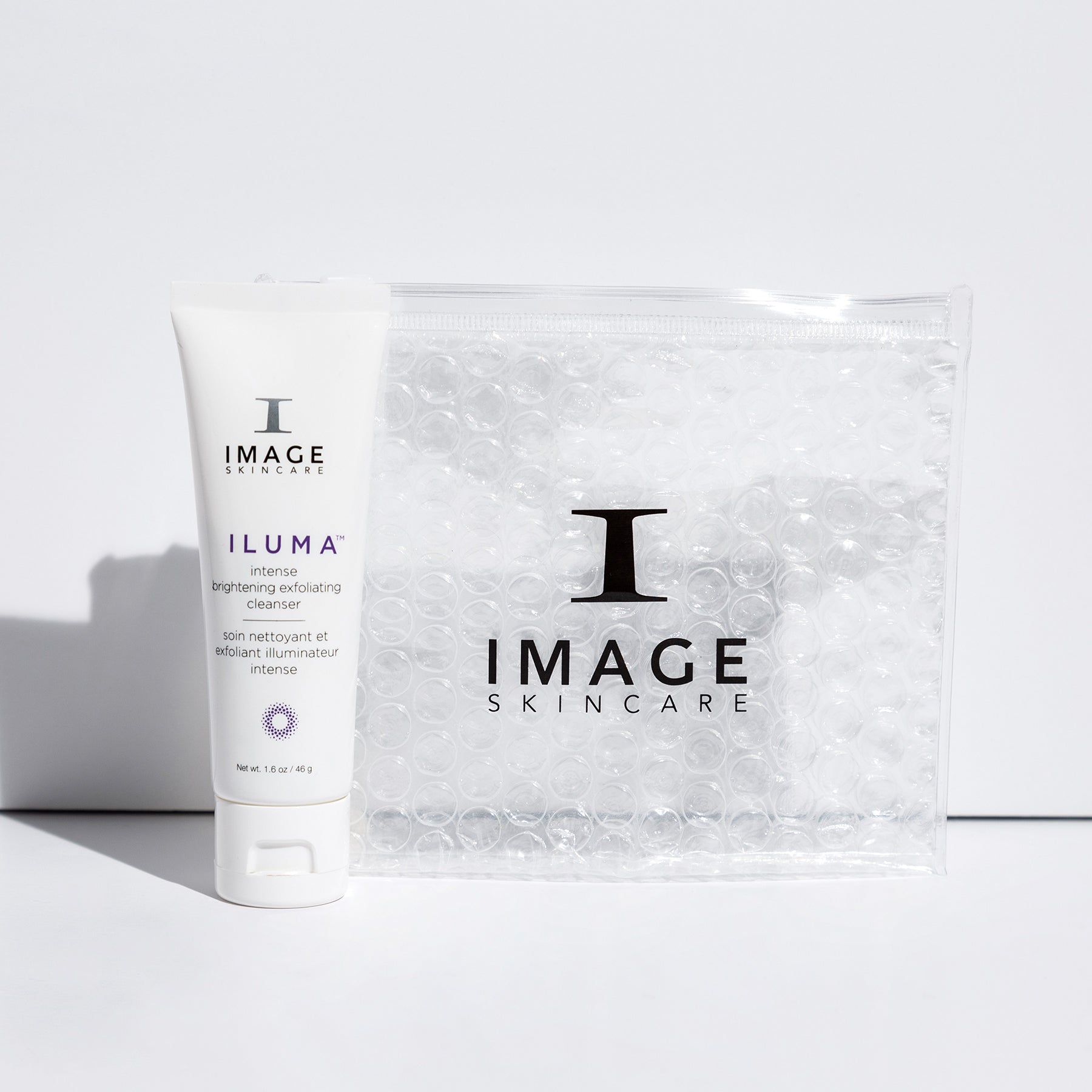 tube of travel size ILUMA cleanser next to white bubble bag 