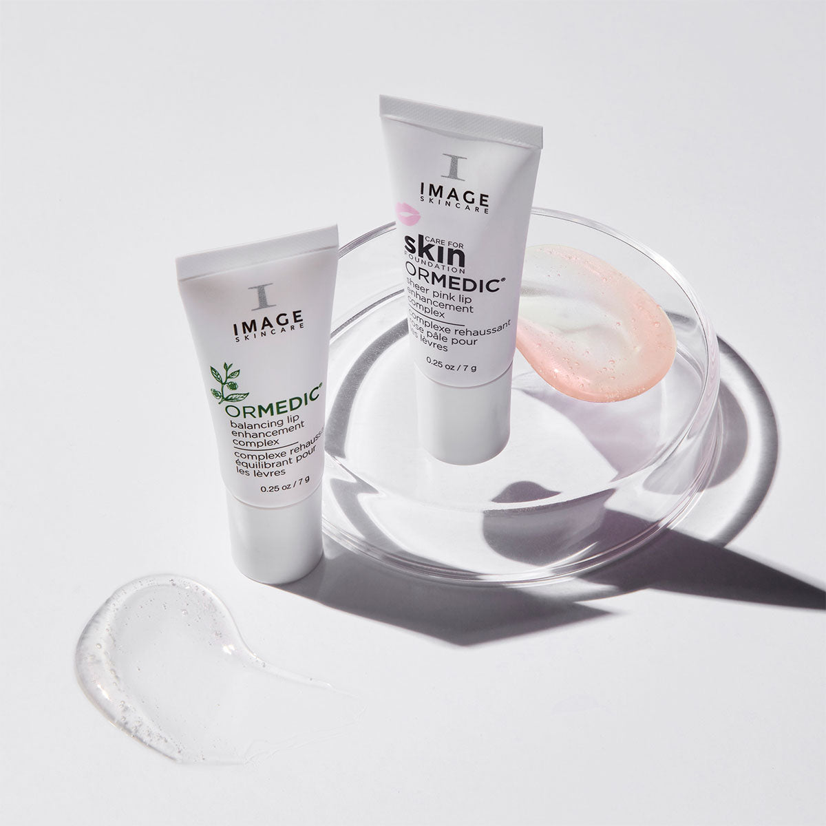 ormedic lip complex and sheer pink lip complex with texture shots of both on white background