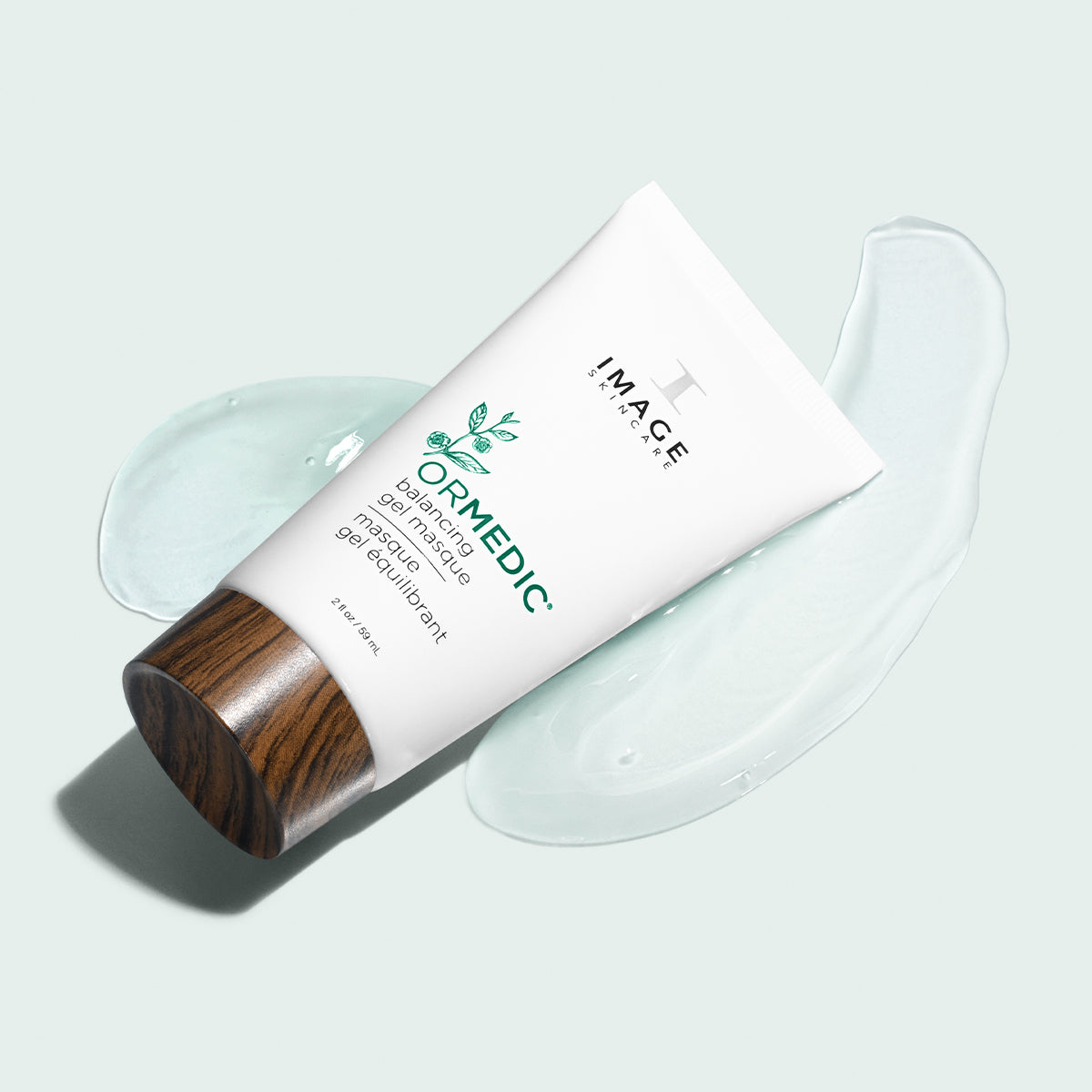 Ormedic gel masque tube laid down on clear gel masque product